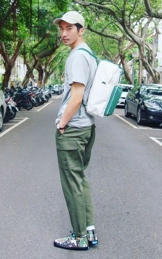 White Canvas Backpack Outfits For Men: A light blue crew-neck t-shirt and a white canvas backpack are absolute staples if you're putting together an off-duty closet that matches up to the highest menswear standards. Olive camouflage leather high top sneakers will take this ensemble in a more sophisticated direction.
