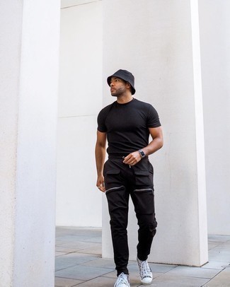 Black Cargo Pants Outfits: This relaxed pairing of a black crew-neck t-shirt and black cargo pants can take on different forms depending on the way you style it. If not sure about what to wear on the footwear front, add grey print canvas high top sneakers to the mix.