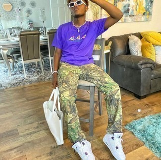 Violet Crew-neck T-shirt Outfits For Men: For comfort dressing with a contemporary spin, you can dress in a violet crew-neck t-shirt and olive camouflage cargo pants. Rounding off with a pair of white leather low top sneakers is a fail-safe way to introduce some extra flair to this outfit.