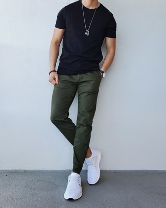 1200+ Casual Hot Weather Outfits For Men: A black crew-neck t-shirt and olive chinos are amazing menswear staples that will integrate really well within your casual styling repertoire. A pair of white athletic shoes effortlessly steps up the cool of your ensemble.