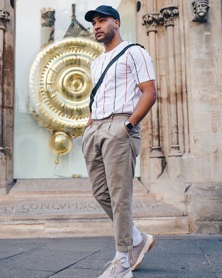 Brown Chinos Relaxed Outfits: The ideal foundation for a knockout laid-back look for men? A white vertical striped crew-neck t-shirt with brown chinos. If you need to easily dial down your outfit with a pair of shoes, complete your ensemble with tan athletic shoes.