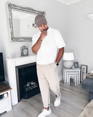 White and Black Athletic Shoes Outfits For Men: If you're scouting for a relaxed casual yet dapper outfit, go for a white crew-neck t-shirt and beige linen chinos. To inject a more casual finish into this look, rock a pair of white and black athletic shoes.