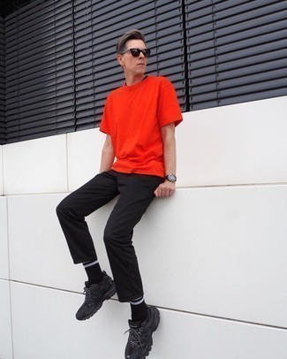 Orange Crew-neck T-shirt Outfits For Men: This pairing of an orange crew-neck t-shirt and black chinos makes for the perfect base for an endless number of dapper looks. A pair of black athletic shoes instantly kicks up the wow factor of this outfit.