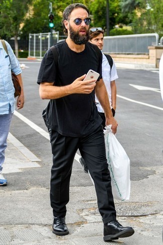 Black Canvas Backpack Outfits For Men: This combination of a black crew-neck t-shirt and a black canvas backpack is a safe bet for a devastatingly dapper look. A pair of black leather casual boots instantly smartens up the outfit.