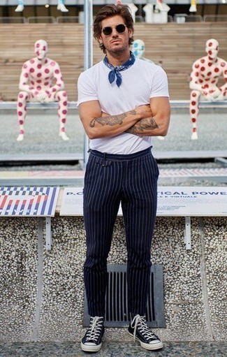 Navy Vertical Striped Chinos Outfits: A white crew-neck t-shirt and navy vertical striped chinos are the kind of a foolproof casual getup that you need when you have no time. Infuse a more casual vibe into your look with black and white canvas high top sneakers.