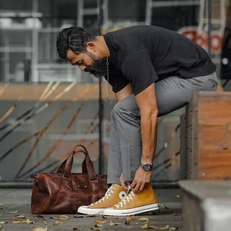 Men's Black Crew-neck T-shirt, Grey Chinos, Tobacco Canvas High Top Sneakers, Dark Brown Leather Duffle Bag