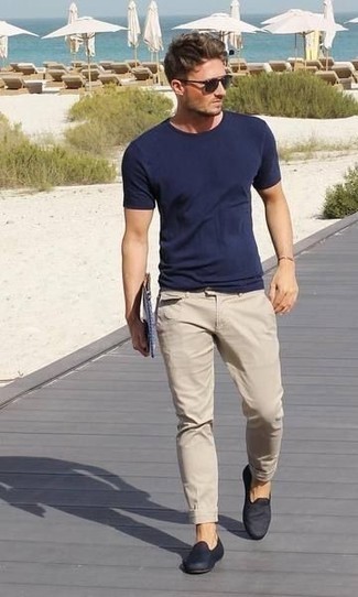 Navy Canvas Loafers Outfits For Men: Nail the casually cool look in a navy crew-neck t-shirt and beige chinos. Complete your ensemble with navy canvas loafers to immediately bump up the classy factor of this look.