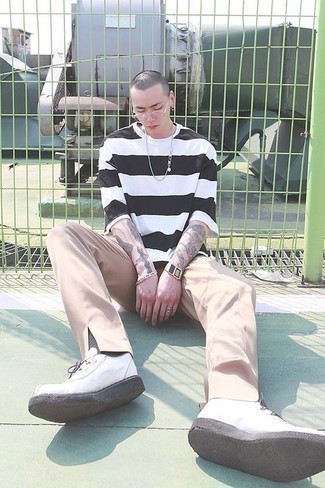 Beige Chinos Outfits: Go for a white and black horizontal striped crew-neck t-shirt and beige chinos for a hassle-free ensemble that's also put together. The whole outfit comes together if you introduce a pair of white canvas low top sneakers to the mix.
