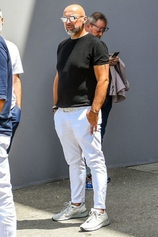 White Low Top Sneakers Outfits For Men: If you want take your off-duty style to a new height, marry a black crew-neck t-shirt with white chinos. Let your outfit coordination credentials truly shine by complementing this ensemble with white low top sneakers.