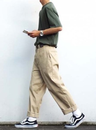 Beige Chinos Hot Weather Outfits: For an ensemble that brings function and dapperness, consider wearing a dark green crew-neck t-shirt and beige chinos. If in doubt about what to wear when it comes to shoes, complement your outfit with a pair of black and white canvas low top sneakers.