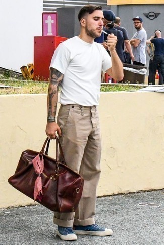 Burgundy Leather Duffle Bag Outfits For Men: Want to inject your menswear collection with some off-duty style? Pair a white crew-neck t-shirt with a burgundy leather duffle bag. Rounding off with blue canvas low top sneakers is an effective way to introduce a bit of classiness to your look.