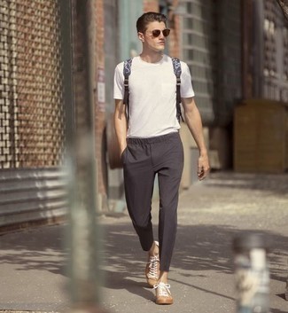 Beige Canvas Low Top Sneakers Outfits For Men: This combination of a white crew-neck t-shirt and charcoal chinos speaks comfort and versatility. Beige canvas low top sneakers are a nice idea to finish your outfit.