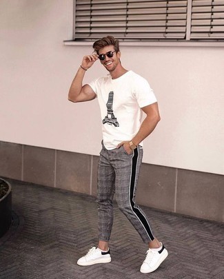 White and Black Leather Low Top Sneakers Outfits For Men: A white and black print crew-neck t-shirt and grey plaid chinos have become a must-have casual combo for many sartorially savvy gents. White and black leather low top sneakers are the glue that will pull your look together.