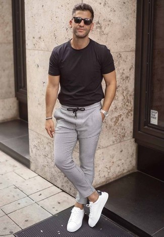 White and Black Check Chinos Outfits: Rock a black crew-neck t-shirt with white and black check chinos for a laid-back kind of sophistication. White and black leather low top sneakers are a wonderful option to complement this ensemble.