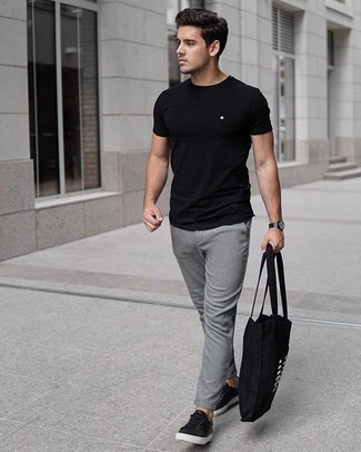 Black Canvas Tote Bag Outfits For Men: This pairing of a black crew-neck t-shirt and a black canvas tote bag will hallmark your skills in menswear styling even on off-duty days. Get a bit experimental in the shoe department and elevate this ensemble by sporting a pair of black leather low top sneakers.