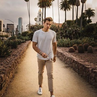 White and Blue Horizontal Striped Crew-neck T-shirt Outfits For Men: This combo of a white and blue horizontal striped crew-neck t-shirt and khaki chinos is a safe bet for an incredibly dapper outfit. A good pair of white canvas low top sneakers ties this ensemble together.