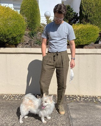 Dark Green Canvas Low Top Sneakers Outfits For Men: If you gravitate towards casual ensembles, why not opt for this pairing of a grey crew-neck t-shirt and olive chinos? Let your sartorial prowess really shine by rounding off this ensemble with dark green canvas low top sneakers.
