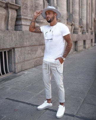 Charcoal Vertical Striped Chinos Outfits: For an off-duty outfit, choose a white crew-neck t-shirt and charcoal vertical striped chinos — these two items fit really well together. When in doubt about the footwear, stick to a pair of white and black leather low top sneakers.