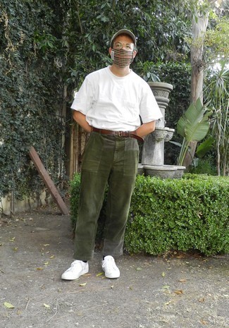 Olive Corduroy Chinos Hot Weather Outfits: Go for a white crew-neck t-shirt and olive corduroy chinos to don a cool and casual look. White canvas low top sneakers are a winning footwear style here that's full of character.