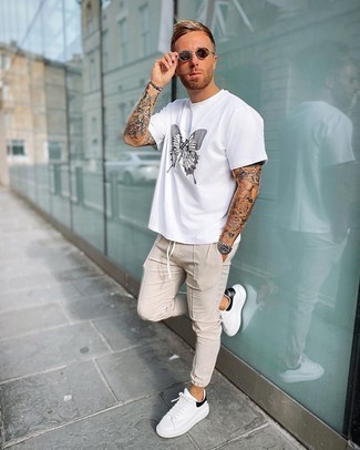 Men's White and Black Print Crew-neck T-shirt, Beige Chinos, White and Black Leather Low Top Sneakers, Dark Brown Sunglasses