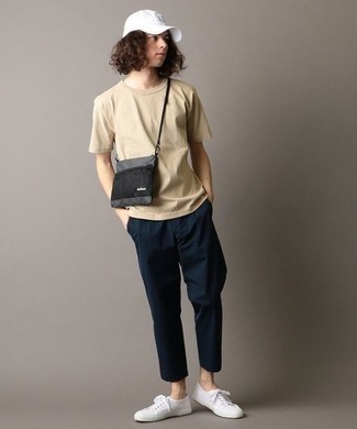 Grey Canvas Messenger Bag Outfits: To pull together a relaxed menswear style with an urban take, wear a beige crew-neck t-shirt and a grey canvas messenger bag. Why not introduce a pair of white canvas low top sneakers to the mix for some extra polish?