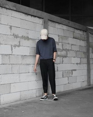 Black Chinos Hot Weather Outfits: You'll be surprised at how very easy it is for any man to throw together this casual ensemble. Just a charcoal crew-neck t-shirt worn with black chinos. Look at how well this ensemble pairs with black and white canvas low top sneakers.