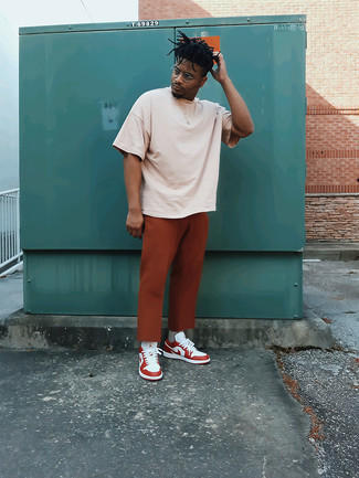 Brown Chinos Hot Weather Outfits: Showcase that you do off-duty like no-one else by wearing a beige crew-neck t-shirt and brown chinos. Consider white and red leather low top sneakers as the glue that will bring this outfit together.