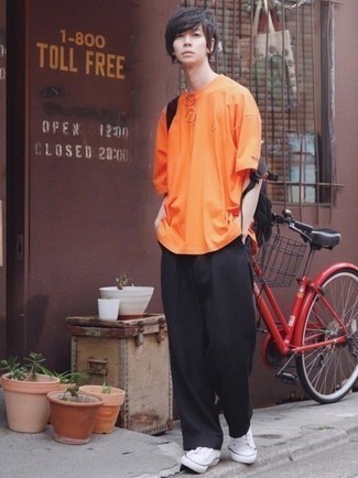 Men's Orange Crew-neck T-shirt, Black Chinos, White Canvas Low Top Sneakers, Black Canvas Backpack