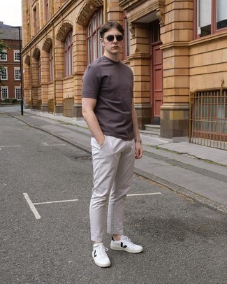 White and Black Leather Shoes with Pants Outfits For Men: Pairing a dark brown crew-neck t-shirt with pants is an awesome pick for a relaxed ensemble. If you need to instantly amp up your outfit with one item, why not complete your ensemble with a pair of white and black leather low top sneakers?