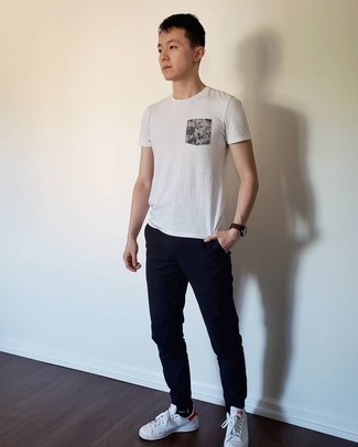 White and Navy Leather Low Top Sneakers Outfits For Men: This pairing of a white print crew-neck t-shirt and navy chinos delivers comfort and efficiency and helps keep it low profile yet contemporary. When it comes to shoes, finish off with white and navy leather low top sneakers.