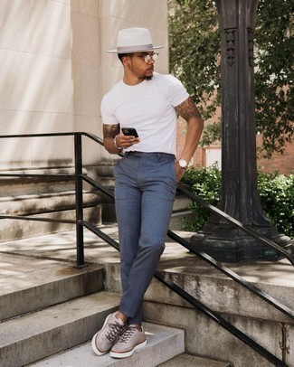 1200+ Hot Weather Outfits For Men: If you don't like putting too much work into your outfits, make a white crew-neck t-shirt and navy check chinos your outfit choice. A pair of grey leather low top sneakers is a wonderful choice to finish off your ensemble.