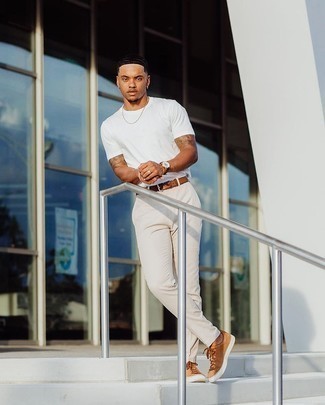 1200+ Hot Weather Outfits For Men: Consider wearing a white crew-neck t-shirt and white chinos and you'll be prepared for whatever this day throws at you. Tan canvas low top sneakers pull the look together.
