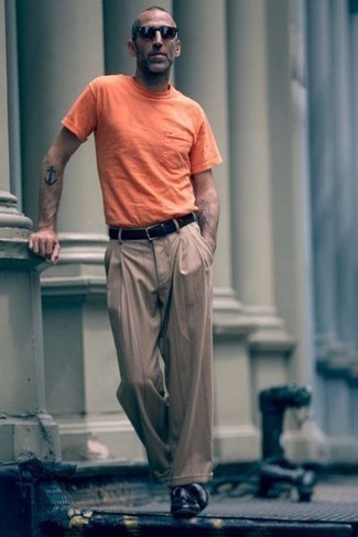 Dark Brown Vertical Striped Chinos Outfits: An orange crew-neck t-shirt and dark brown vertical striped chinos are among those extremely versatile menswear essentials that can completely change your wardrobe. Bump up the fashion factor of this outfit by wearing a pair of black leather tassel loafers.