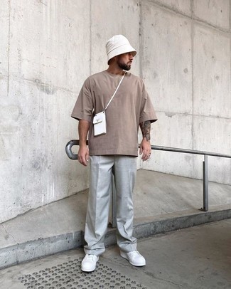 White Bucket Hat Outfits For Men: We're all scouting for practicality when it comes to fashion, and this modern casual combination of a tan crew-neck t-shirt and a white bucket hat is a practical example of that. Go ahead and add a pair of white canvas low top sneakers to the equation for an extra touch of style.