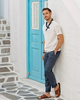 Navy Vertical Striped Dress Pants Outfits For Men: Pairing a white crew-neck t-shirt and navy vertical striped dress pants is a fail-safe way to infuse your wardrobe with some laid-back sophistication. Add a carefree touch to with brown leather sandals.