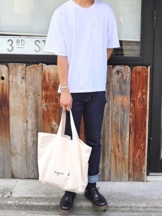 Beige Canvas Tote Bag Outfits For Men: A white crew-neck t-shirt and a beige canvas tote bag are the kind of a never-failing casual outfit that you so awfully need when you have no extra time to assemble an ensemble. Introduce black leather derby shoes to the equation to avoid looking too casual.