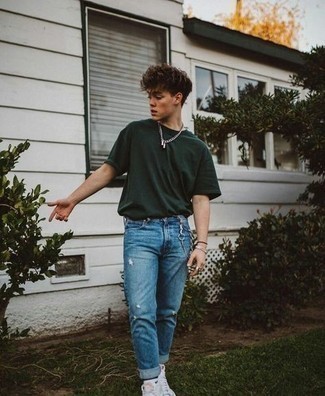 Blue Ripped Jeans Outfits For Men: A dark green crew-neck t-shirt and blue ripped jeans are the perfect way to introduce extra cool into your casual styling arsenal. If you're not sure how to finish, complete your getup with white print canvas high top sneakers.