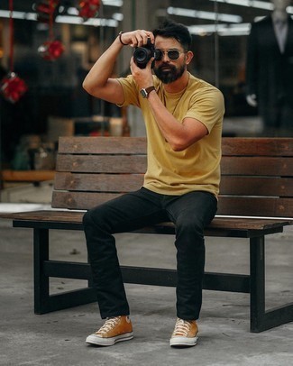 Yellow Canvas High Top Sneakers Outfits For Men: For a casually stylish ensemble, go for a yellow crew-neck t-shirt and black jeans — these pieces play wonderfully together. To give your overall look a more casual aesthetic, add a pair of yellow canvas high top sneakers to your outfit.
