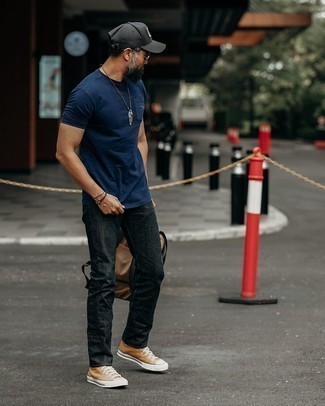Beige Canvas High Top Sneakers Outfits For Men: A navy crew-neck t-shirt and black jeans work together beautifully. For something more on the casually cool end to finish off this ensemble, introduce a pair of beige canvas high top sneakers to the equation.
