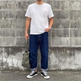 Men's Outfits 2021: If you appreciate comfort dressing, consider wearing a white crew-neck t-shirt and navy jeans. Introduce a pair of black and white canvas low top sneakers to the equation and ta-da: the outfit is complete.