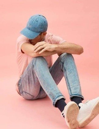 Light Blue Baseball Cap Outfits For Men: We're all seeking functionality when it comes to fashion, and this street style pairing of a pink crew-neck t-shirt and a light blue baseball cap is a good illustration of that. Why not take a classier approach with shoes and throw a pair of white leather low top sneakers into the mix?