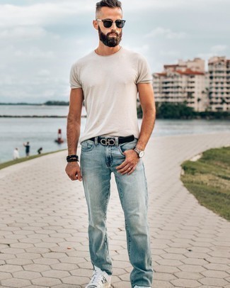 Black and Silver Leather Belt Outfits For Men: Consider wearing a white crew-neck t-shirt and a black and silver leather belt for a casual and fashionable getup. Puzzled as to how to complement this look? Wear white and black leather low top sneakers to bump it up a notch.