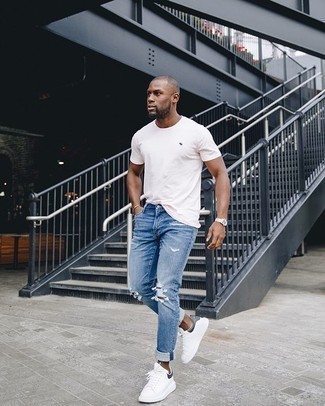 Navy Ripped Jeans Outfits For Men: To achieve a laid-back ensemble with an edgy spin, make a white crew-neck t-shirt and navy ripped jeans your outfit choice. Dial down the casualness of your ensemble by wearing a pair of white and black canvas low top sneakers.