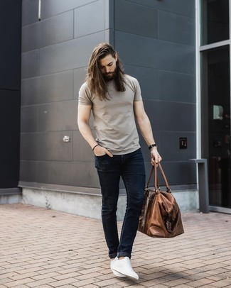 Brown Leather Duffle Bag Outfits For Men: If it's ease and practicality that you appreciate in an outfit, consider wearing a beige crew-neck t-shirt and a brown leather duffle bag. For something more on the classy side to complete this outfit, introduce a pair of white canvas low top sneakers to the equation.