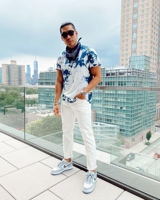 White Leather Watch Outfits For Men: A white and navy tie-dye crew-neck t-shirt and a white leather watch are the ideal way to introduce some cool into your daily arsenal. Let your outfit coordination skills truly shine by finishing off with grey print leather low top sneakers.