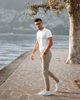 Khaki Jeans Outfits For Men: This combo of a white crew-neck t-shirt and khaki jeans makes for the perfect base for a casual and cool look. Add white leather low top sneakers to the equation and off you go looking dashing.