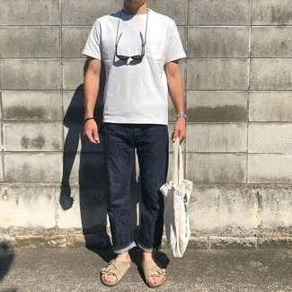 121 Relaxed Outfits For Men: The versatility of a white crew-neck t-shirt and navy jeans ensures they will always be on permanent rotation in your closet. And if you want to effortlessly dial down this getup with one item, why not introduce beige suede sandals to the equation?