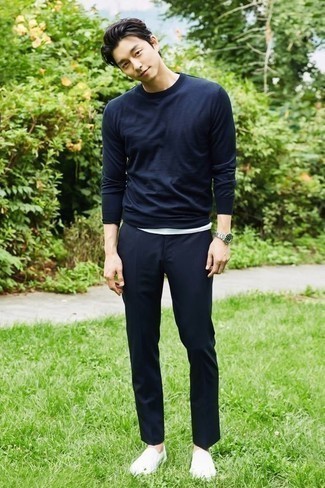 White Canvas Slip-on Sneakers Outfits For Men: For a casual outfit, go for a navy long sleeve t-shirt and navy chinos — these items play really good together. Our favorite of a great number of ways to complement this look is a pair of white canvas slip-on sneakers.