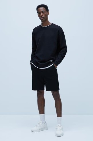 White Athletic Shoes Outfits For Men: This combination of a navy long sleeve t-shirt and black sports shorts makes for the perfect base for a casually cool getup. White athletic shoes pull the getup together.