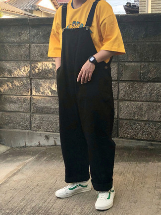 Overalls Outfits For Men: For a laid-back ensemble, go for a mustard print crew-neck t-shirt and overalls — these pieces play pretty good together. Rounding off with white and green canvas low top sneakers is the most effective way to introduce some extra definition to this look.